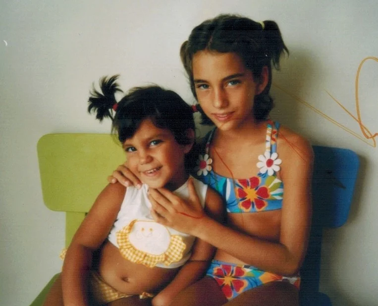 Young Maria with her sister